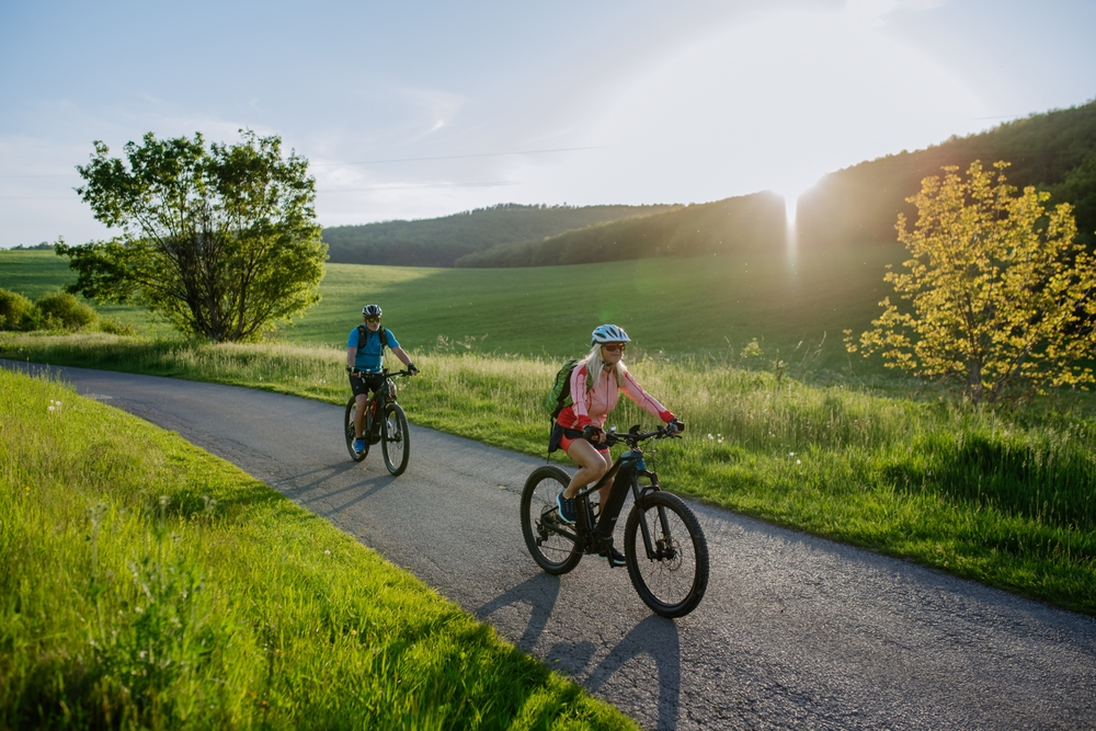 senior couple riding bicycles outdoors