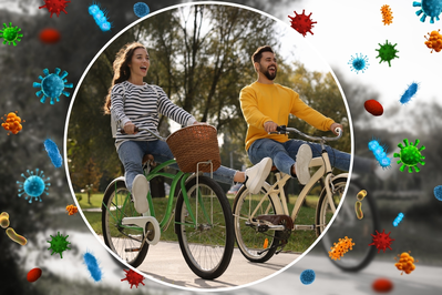 couple with strong immunity riding bicycles outdoors with bubble around them blocking viruses