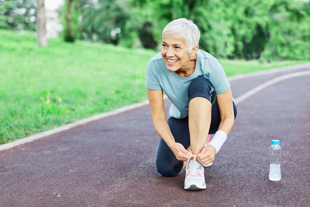 Woman tying her shoe during a run